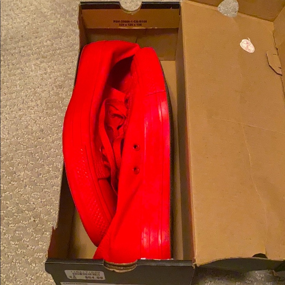 A pair of red converse sneakers